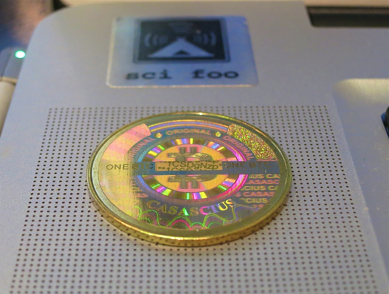 A physical Casascius bitcoin, a brass coin with the Bitcoin symbol