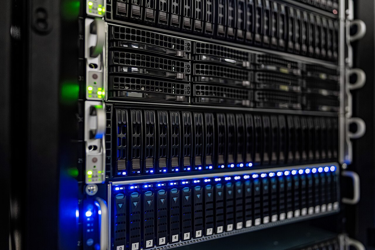 Rows of rack-mounted servers with blue status lights in a data center